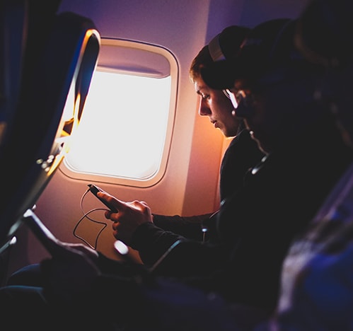 Man listening to audiobooks on an airplane