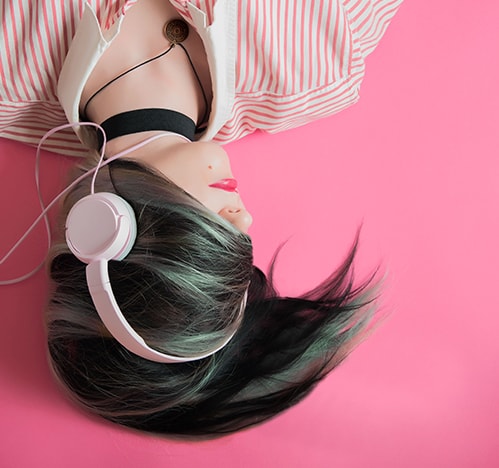 Woman listening to audiobooks through headphones